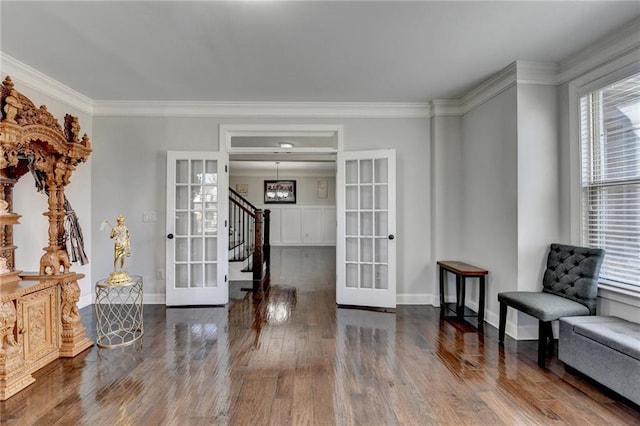 entrance foyer featuring crown molding, french doors, baseboards, and wood finished floors