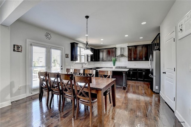 dining room with dark wood-style flooring, baseboards, and recessed lighting
