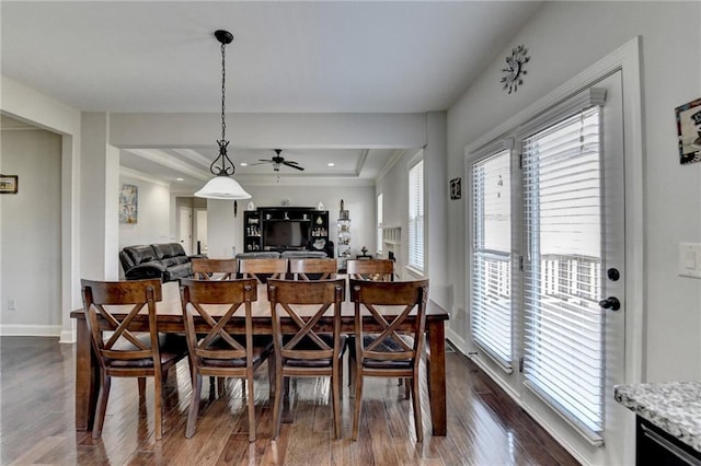 dining room featuring baseboards, ceiling fan, and dark wood finished floors