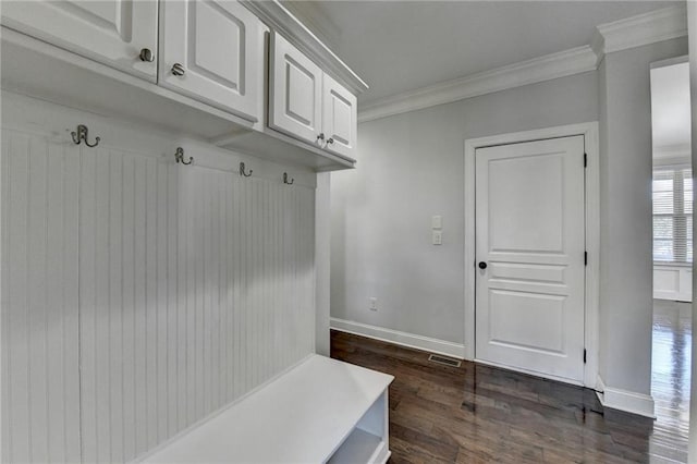 mudroom with dark wood-type flooring, ornamental molding, baseboards, and visible vents