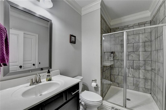 bathroom with a shower stall, crown molding, and toilet