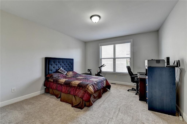 carpeted bedroom featuring baseboards
