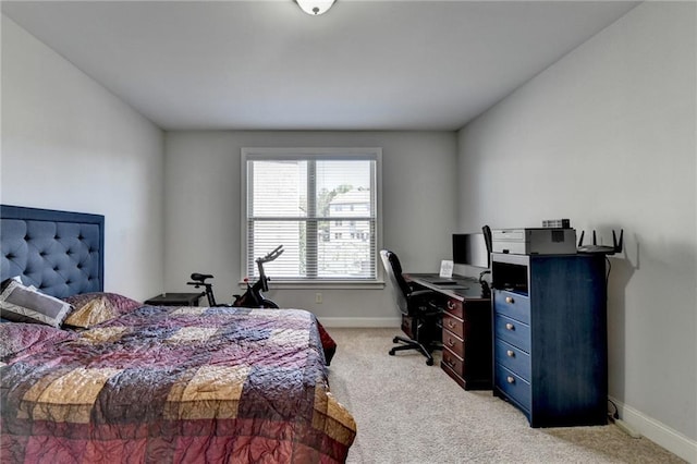 bedroom featuring light colored carpet and baseboards