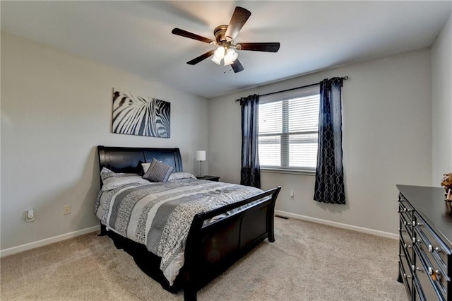 bedroom featuring light carpet, baseboards, and a ceiling fan
