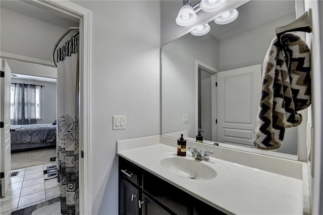 full bathroom with tile patterned floors, connected bathroom, and vanity