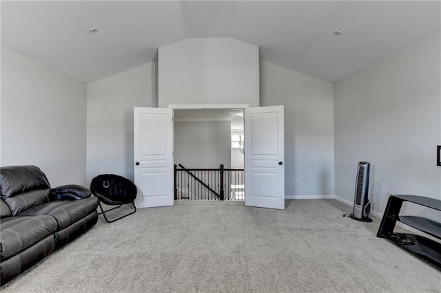 living area featuring carpet flooring, an upstairs landing, high vaulted ceiling, and baseboards