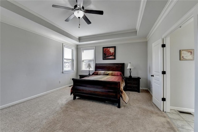 bedroom featuring a tray ceiling, crown molding, light colored carpet, and visible vents