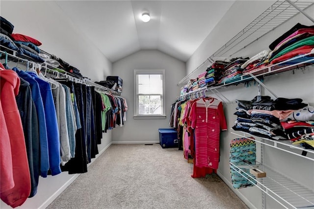 spacious closet with carpet flooring and vaulted ceiling