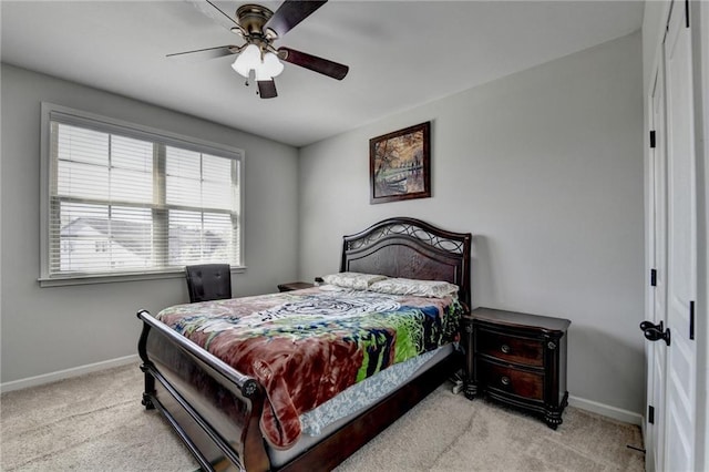 bedroom featuring baseboards, ceiling fan, and carpet