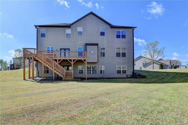 rear view of house with a yard, a wooden deck, and stairs