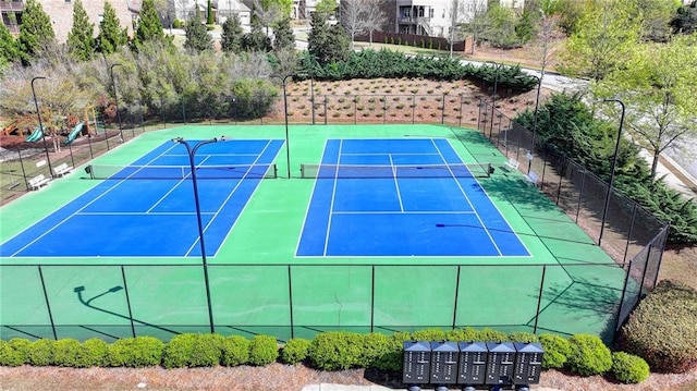 view of tennis court featuring fence