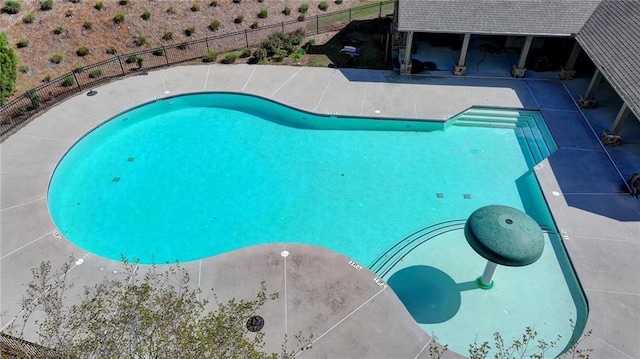 view of swimming pool with a patio, a fenced in pool, and fence