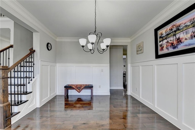 unfurnished dining area with a decorative wall, a notable chandelier, and ornamental molding
