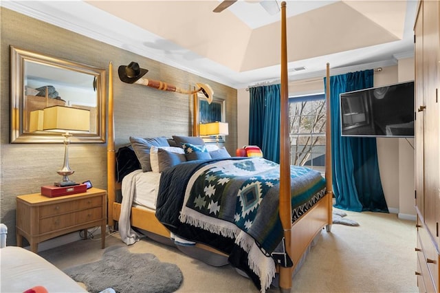 carpeted bedroom featuring ornamental molding, lofted ceiling, and a tray ceiling