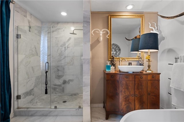 bathroom with a shower with door and vanity