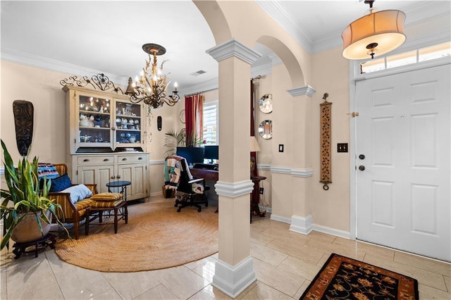 entryway with crown molding, decorative columns, and a notable chandelier