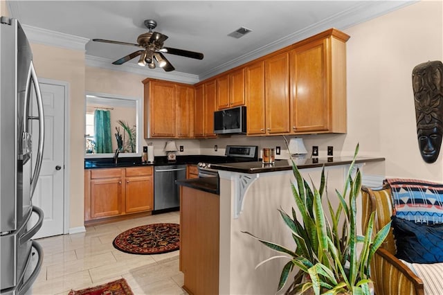 kitchen with appliances with stainless steel finishes, sink, ornamental molding, ceiling fan, and kitchen peninsula