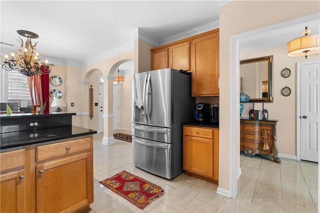 kitchen with crown molding, stainless steel fridge, and light tile patterned flooring