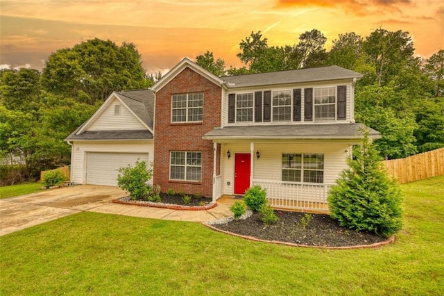 207 Belmont Dr, Monroe, GA 30655 - view of front of house featuring fence, covered porch, brick siding, concrete driveway, and an attached garage