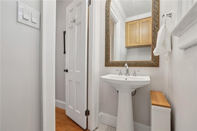 bathroom with baseboards and wood finished floors