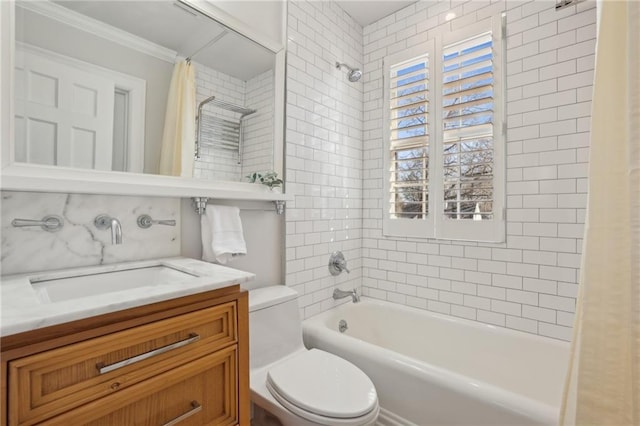 full bathroom featuring ornamental molding, vanity, toilet, and shower / tub combo with curtain