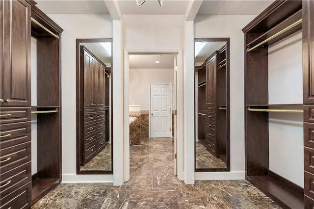 walk in closet with marble finish floor