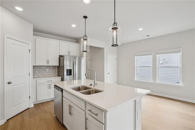 2026 Avalon Rdg, Conyers, GA 30013 - kitchen with pendant lighting, sink, dishwasher, white cabinetry, and a kitchen island with sink