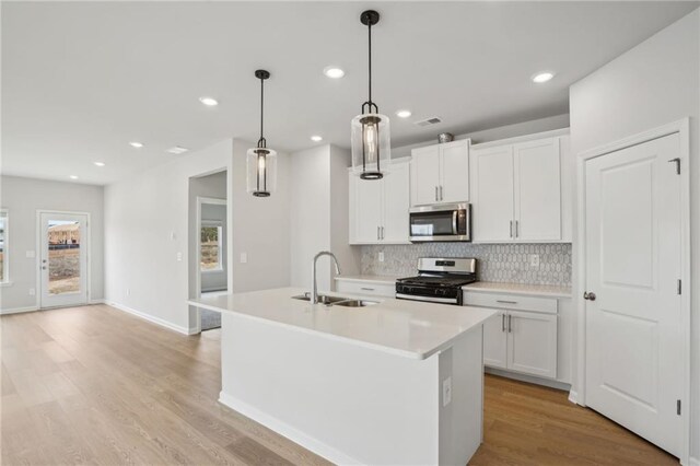 2026 Avalon Rdg, Conyers, GA 30013 - kitchen featuring sink, stainless steel appliances, white cabinets, and a center island with sink
