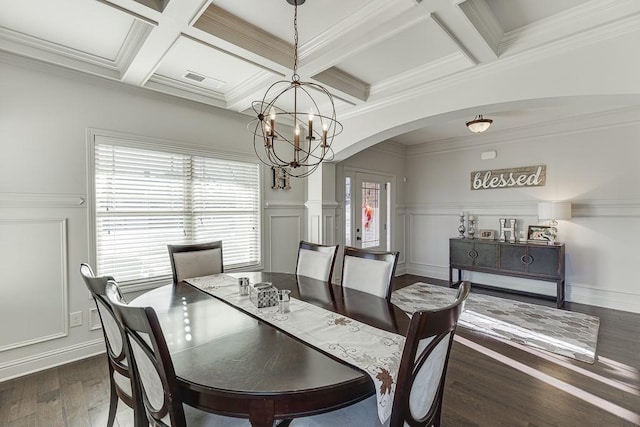 dining space with arched walkways, dark wood-style floors, beam ceiling, and an inviting chandelier