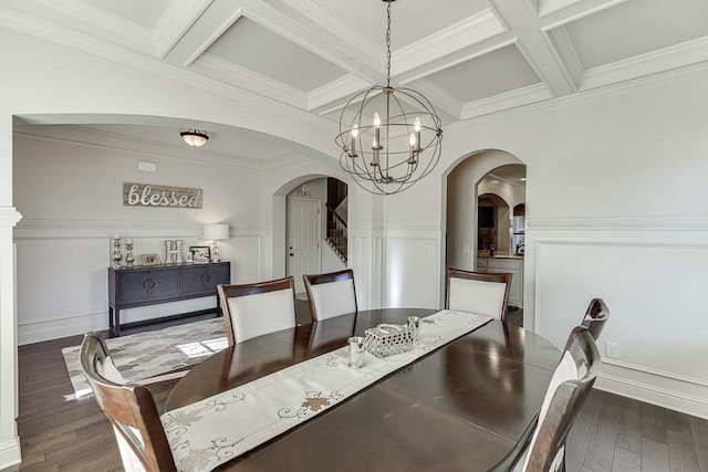 dining room with dark wood-style floors, arched walkways, and beam ceiling