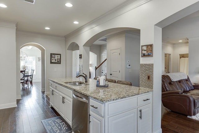 kitchen featuring a sink, white cabinets, stainless steel dishwasher, dark wood finished floors, and a center island with sink