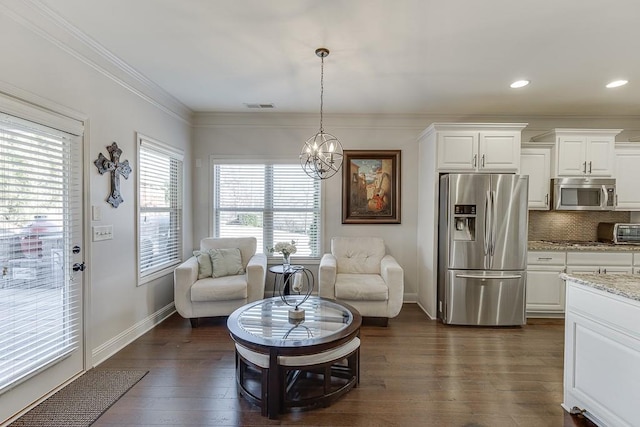 sitting room featuring dark wood finished floors, crown molding, visible vents, a chandelier, and baseboards