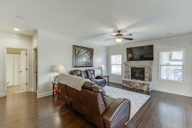 living room with dark wood-style floors, ornamental molding, a fireplace, and baseboards