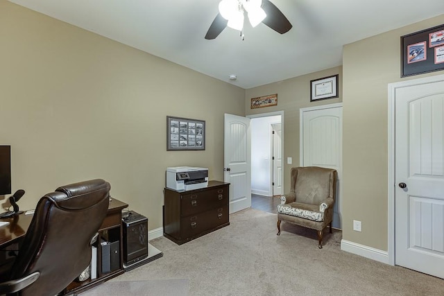 office area with light carpet, ceiling fan, and baseboards