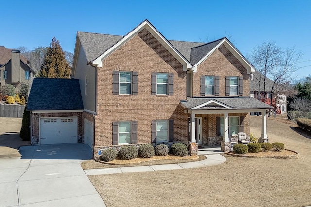 view of front of property with a garage, a porch, concrete driveway, and brick siding