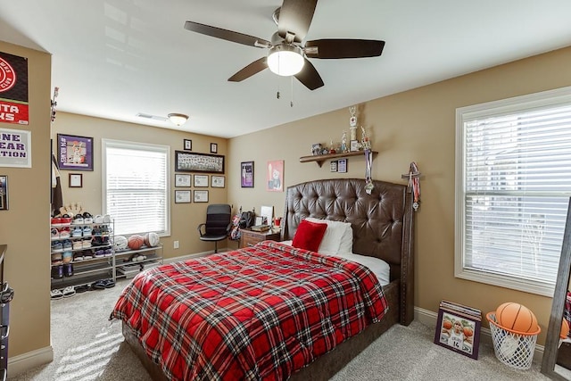 bedroom with multiple windows, carpet, and baseboards