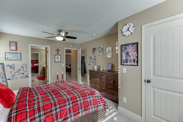 bedroom with light carpet, ceiling fan, and baseboards