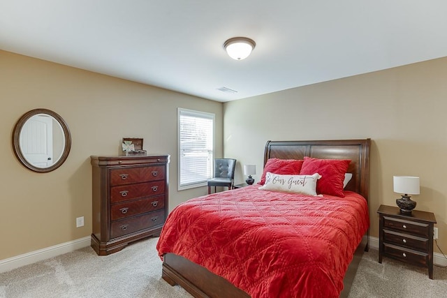 carpeted bedroom with visible vents and baseboards