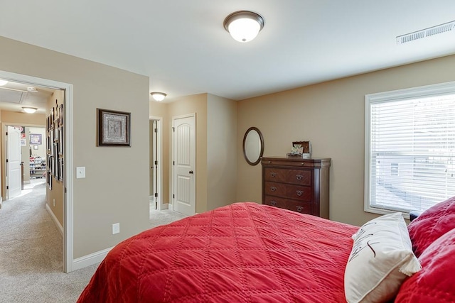 bedroom featuring light carpet, baseboards, visible vents, and attic access