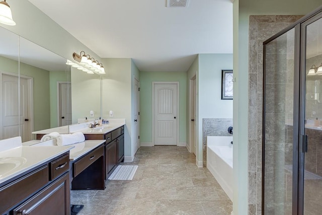 full bath with a garden tub, a shower stall, baseboards, and vanity