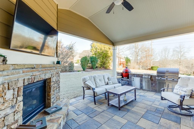 view of patio with ceiling fan, grilling area, an outdoor hangout area, and an outdoor kitchen