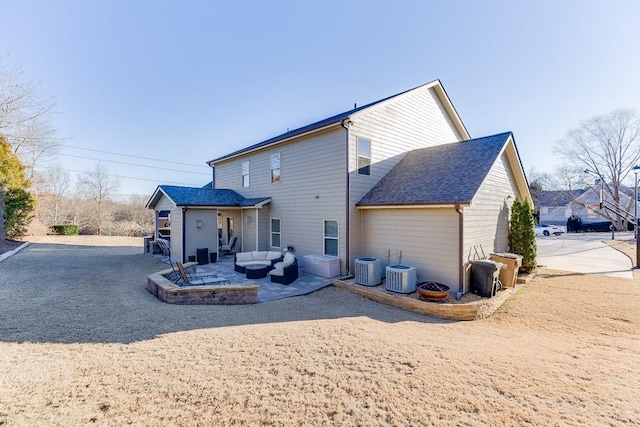 rear view of property with a patio, roof with shingles, cooling unit, and an outdoor living space