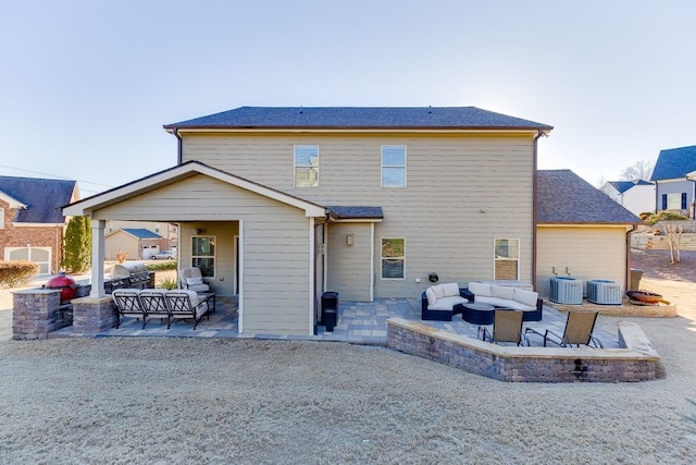 rear view of house with a patio area, outdoor lounge area, and cooling unit