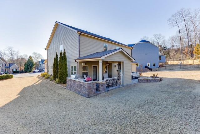 view of front facade with a patio and fence