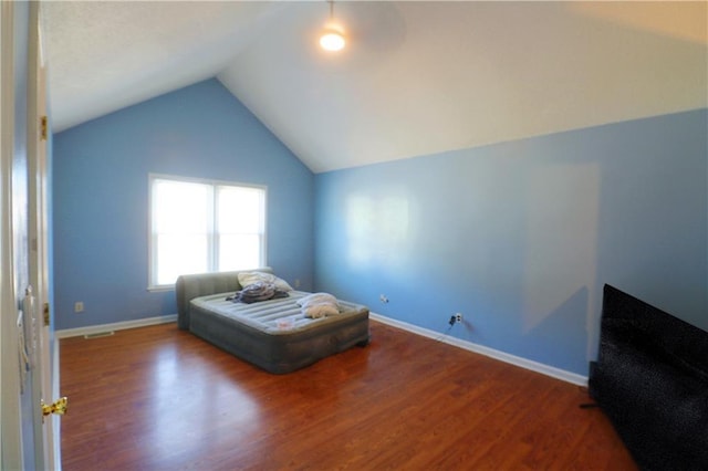 bedroom with hardwood / wood-style floors and vaulted ceiling