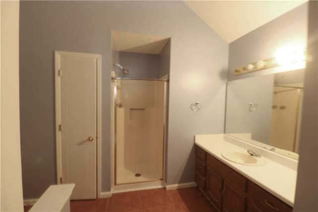 bathroom with a shower with shower door, vanity, lofted ceiling, and tile patterned flooring