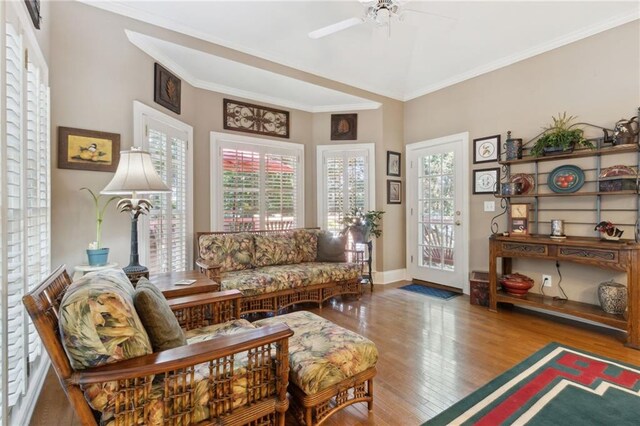 dining room featuring ceiling fan with notable chandelier, built in desk, decorative columns, and hardwood / wood-style floors