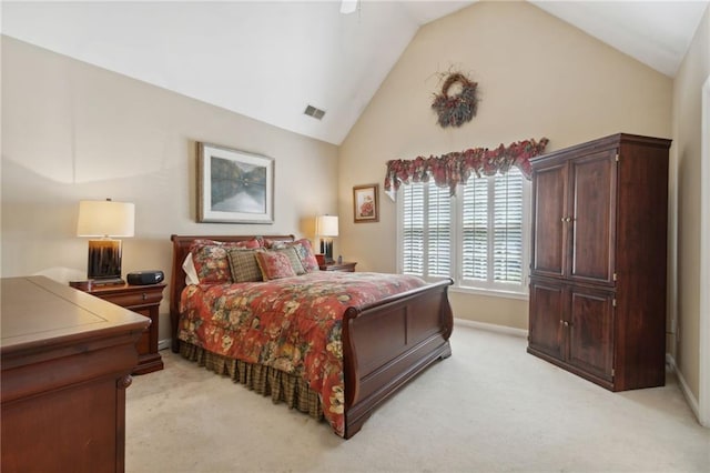 carpeted bedroom with high vaulted ceiling