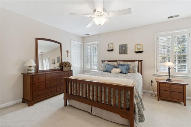 bedroom with ceiling fan and light carpet