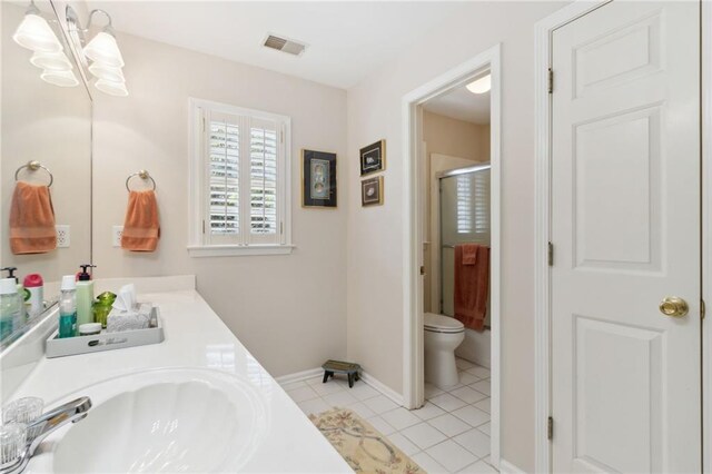 bathroom with walk in shower, tile patterned floors, toilet, an inviting chandelier, and vanity